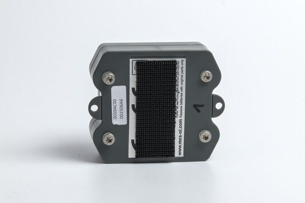 Small white GPS tracking unit with its casing open, circuit board visible