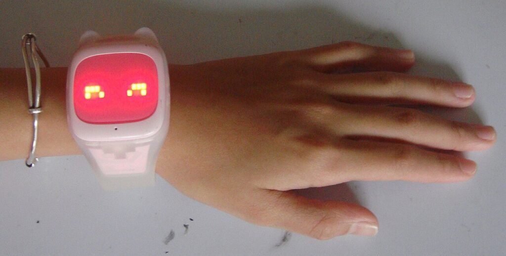 Child wearing a chunky phone watch on the wrist