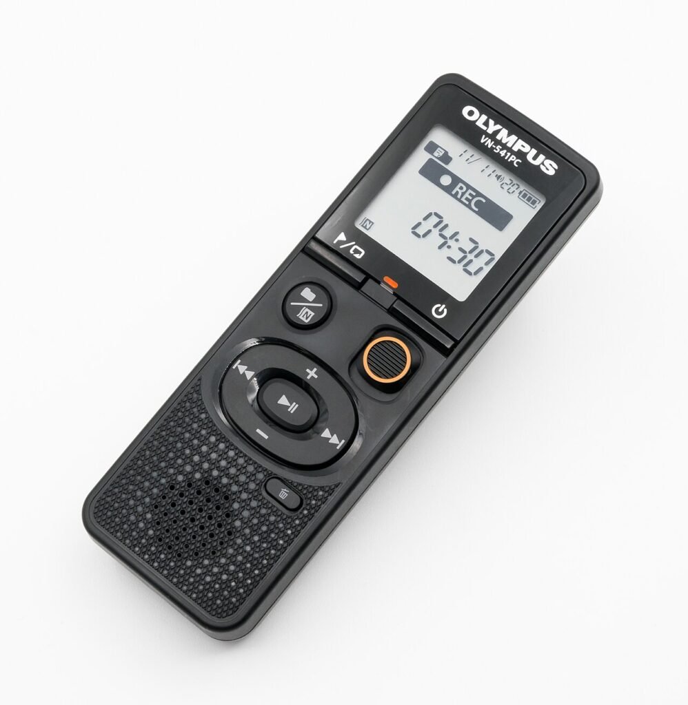 Handheld Olympus digital voice recorder with a small monochrome screen