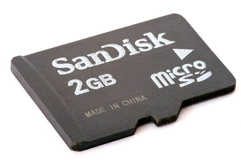 MicroSD card photographed close up, gold contacts facing the camera
